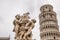 The marble Fountain of Angels Fontana dei Putti in front of The Leaning Tower of Pisa.  Tuscany, Italy