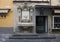 A marble fountain with entwined fish adorning a small store on a narrow street in Sorrento, Italy