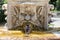 Marble fountain in the shape of the head of a man in the gardens of Villa Borghese, Rome