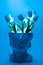 Marble head flower pot with tulips and teal led background.