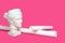 Marble head of young woman, ancient Greek goddess bust with paper rolls or scrolls on pink background. Architecture, art