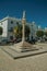 Marble pillory in deserted square with old buildings