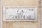 Marble plate with Street name via del Giardini - engl: Giardini street - at the wall in Rome