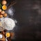 Marble rolling pin with flour and eggs on a dark background. Baking background. Baking background. Baking ingredients: flour, eggs