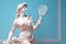 Marble statue of an ancient Greek goddess doing sports on pastel background. Tennis player sculpture. Beauty standards, ideal body