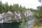 Marble stone quarry view next to lake and trees