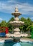 Marble or stone water fountain in Children`s World Park, Bucharest. Water fountain against clear blue sky