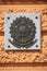 A marble tablet with the bronze national emblem of Brazil on the wall of the consulate, close-up