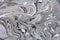 Marble texture formed by mixing white gray  paints, abstract background