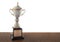 Marble trophy on wooden table isolated. Winning awards with copy space