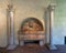 Marble wall fountain flanked by capitals in the Cloisters in New York City.