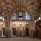 Marble wall with mihrab niche, wooden doors, huge arches and stained glass windows, Khayer Bek Mausoleum, Old Cairo, Egypt