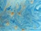 Marbled blue and golden abstract background. Liquid marble pattern