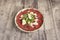 Marbled dish with typical Italian beef carpaccio with arugula and parmesan cheese flakes