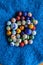 Marbles colourful in  group on blue fabric background