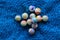 Marbles colourful in  group on blue fabric background  landscape format