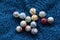 Marbles colourful in  group on blue fabric background  landscape format