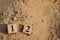 March 12, Number cube with Sand background.