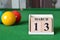 March 13, number cube with balls on snooker table, sport background.