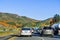 March 16, 2019 Lake Elsinore / CA / USA - Cars driving through hills covered in California poppies during the superbloom in south