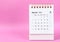 A March 2023 desk calendar on pink color background