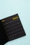 March 2025 Black calendar opening on blue background