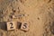 March 25, Number cube with Sand background.