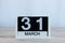 March 31st. Day 31 of month, everyday calendar on wooden table background. Spring time, empty space for text