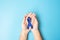 March Colorectal Cancer Awareness month, Man holding dark Blue Ribbon for supporting people living and illness. Healthcare, hope