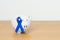 March Colorectal Cancer Awareness month, Navy Blue Ribbon with Piggy Bank for support illness life. Health, Donation, Charity,