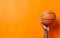 March madness poster. A hand holding a photorealistic orange basketball ball on warm yellow background. AI Generative