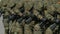 March military officers with assault rifle kalashnikov ak 47 in arm closeup 4K.