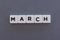 March word made of square letter word on grey background