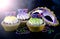 Mardi Gras Cupcakes with face mask decorations, with lens flare.
