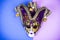 Mardi Gras Festival. Luxurious masquerade Venetian carnival mask on purple background