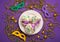 Mardi Gras King Cake Sufganiyot Donuts, Carnival Masks on Purple Background