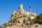 Mardin Castle and Turkish flag view. Old Mardin, Turkey