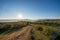 Maremma countryside panoramic view, olive trees, rolling hills and green fields. Sea on the horizon. Casale Marittimo