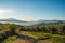 Maremma countryside panoramic view, olive trees, rolling hills and green fields. Sea on the horizon. Casale Marittimo