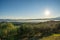 Maremma countryside panoramic view, olive trees, rolling hills and green fields. Sea on the horizon. Casale Marittimo