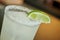 Margarita cocktail consisting of tequila, orange liqueur, and lime juice served with salt on the rim of the glass, slice of lime