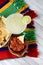 Margaritas and Mexican food on a colorful table cloth and wood