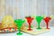 Margaritas in red and green glasses with salted rims and lime garnishes