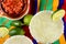 Margaritas and Salsa on a colorful table cloth, with limes, and