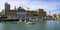 Margherita Theater and fishing row boat in old harbor of Bari.