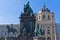 Maria Theresa statue in a garden with a lot of historical figures around her in front of Art History museum in Vienna