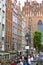 Mariacka street with colorful facades of tenement houses and 16th century gothic St. Mary`s Church, Gdansk, Poland