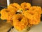 Marigold flower garlands on a gold color pedestal.