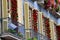 Marilin mannequin on a balcony of a building where the facade is covered with red roses, Barcelona Spain