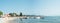 Marina and bathers on the shores of Lake Garda on a sunny morning